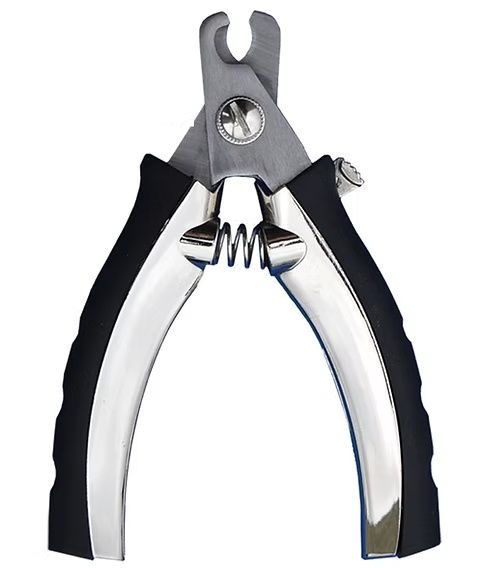 A close-up of scissor-style nail clippers being aligned carefully with a pet's claw